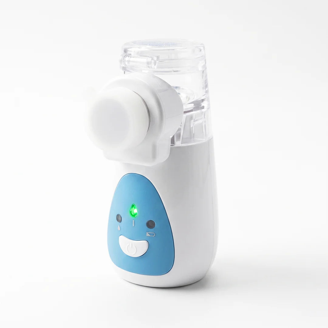 A handheld facial cleansing brush with a white and light blue body, featuring a clear plastic cup and a white circular brush head, shown on a clean white background.